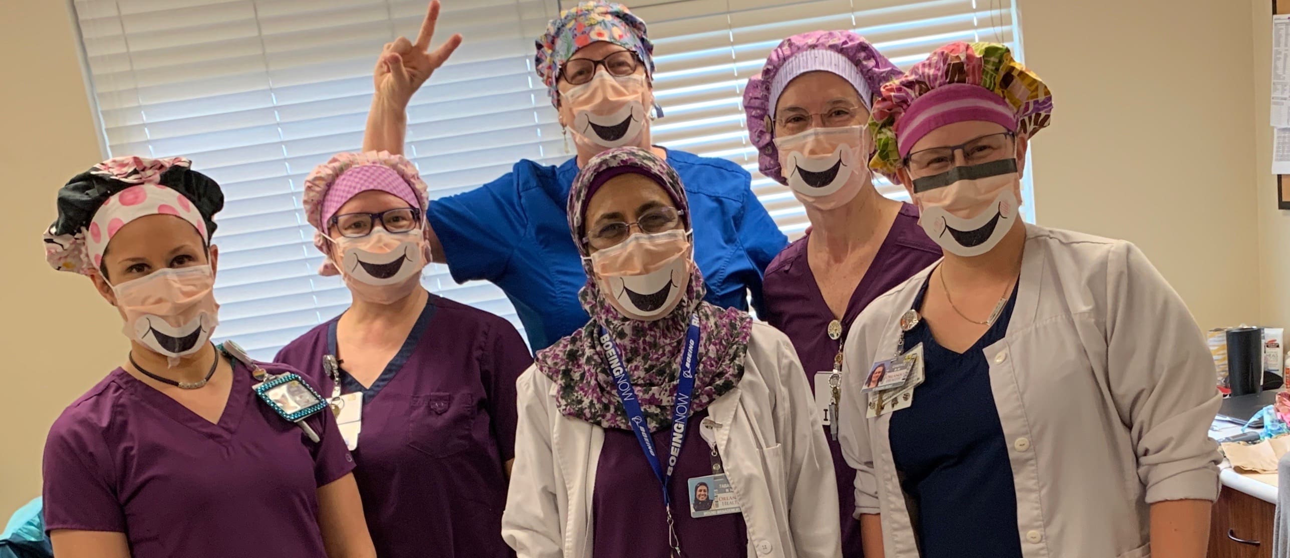 Healthcare workers wearing smiling masks.