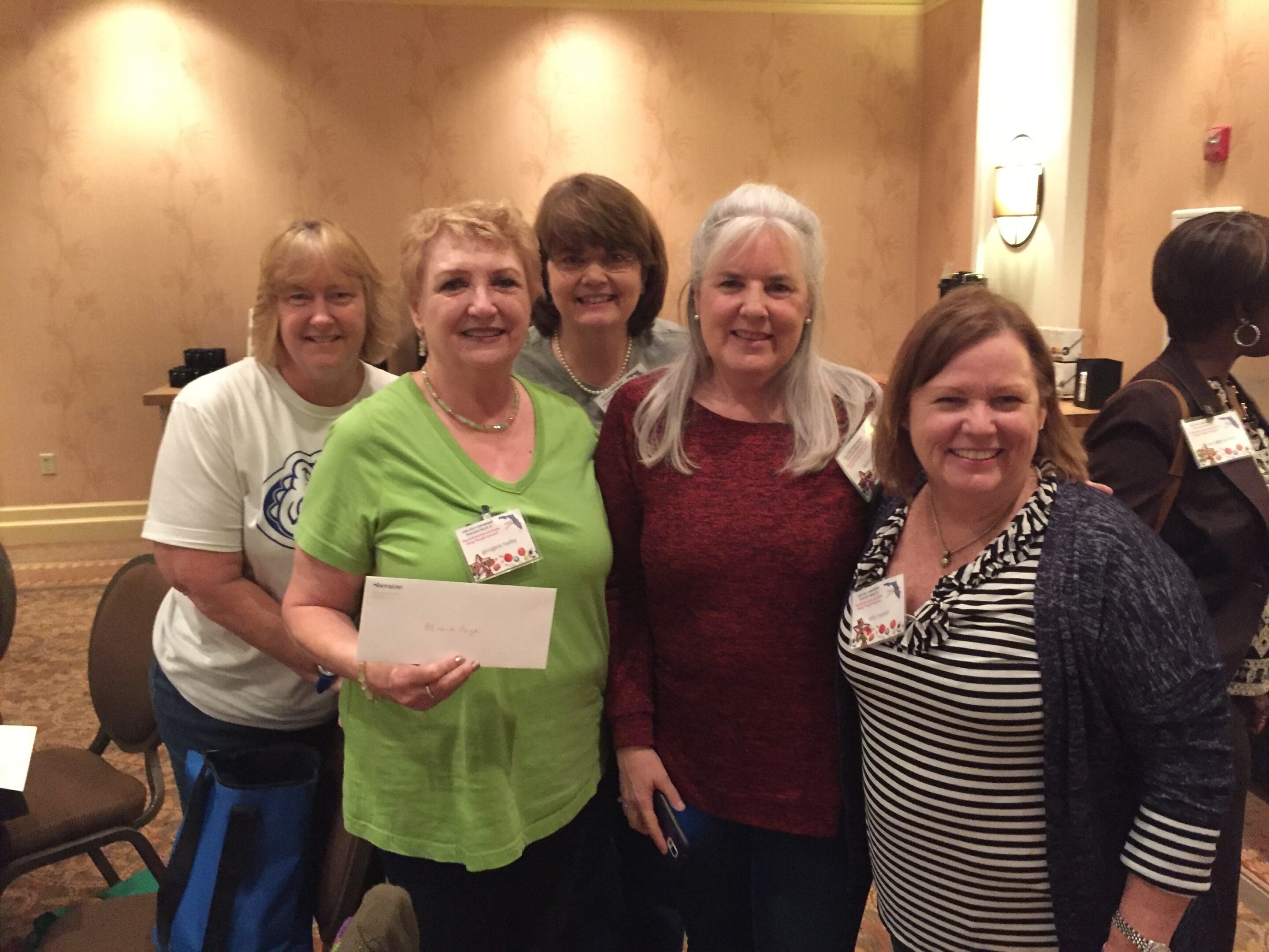 Group of women smiling at a conference.